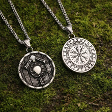 Viking Tyr Vegvisir Necklace with round silver pendants featuring shield and runic compass design on moss background