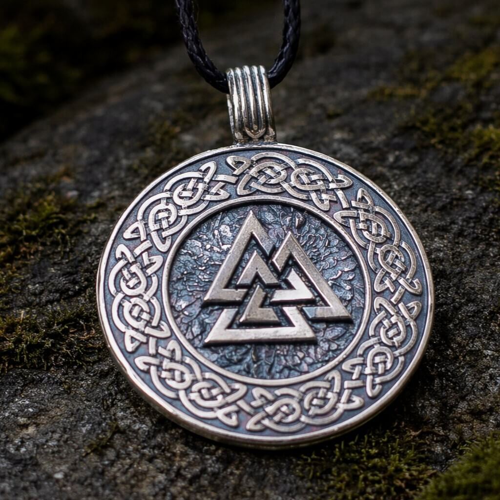 Viking Valknut Celtic knot pendant: silver-toned metal, black cord, dark background.