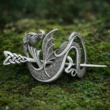 Viking Winged Dragon Hair Clip in silver, featuring detailed scales and knotwork, displayed on lush green moss.