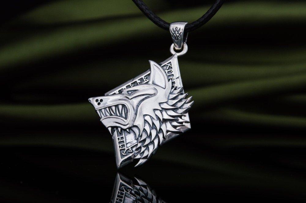 Sterling silver Viking wolf head pendant with intricate details on a black cord.