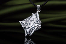 Sterling silver Viking wolf head pendant with intricate details on a black cord.