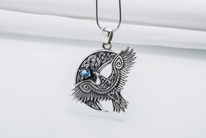 Viking 925 silver raven pendant with intricate Celtic knotwork and a blue gemstone.